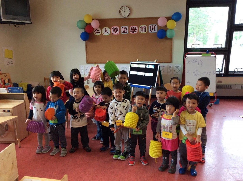 A group of children hold paper lanterns.